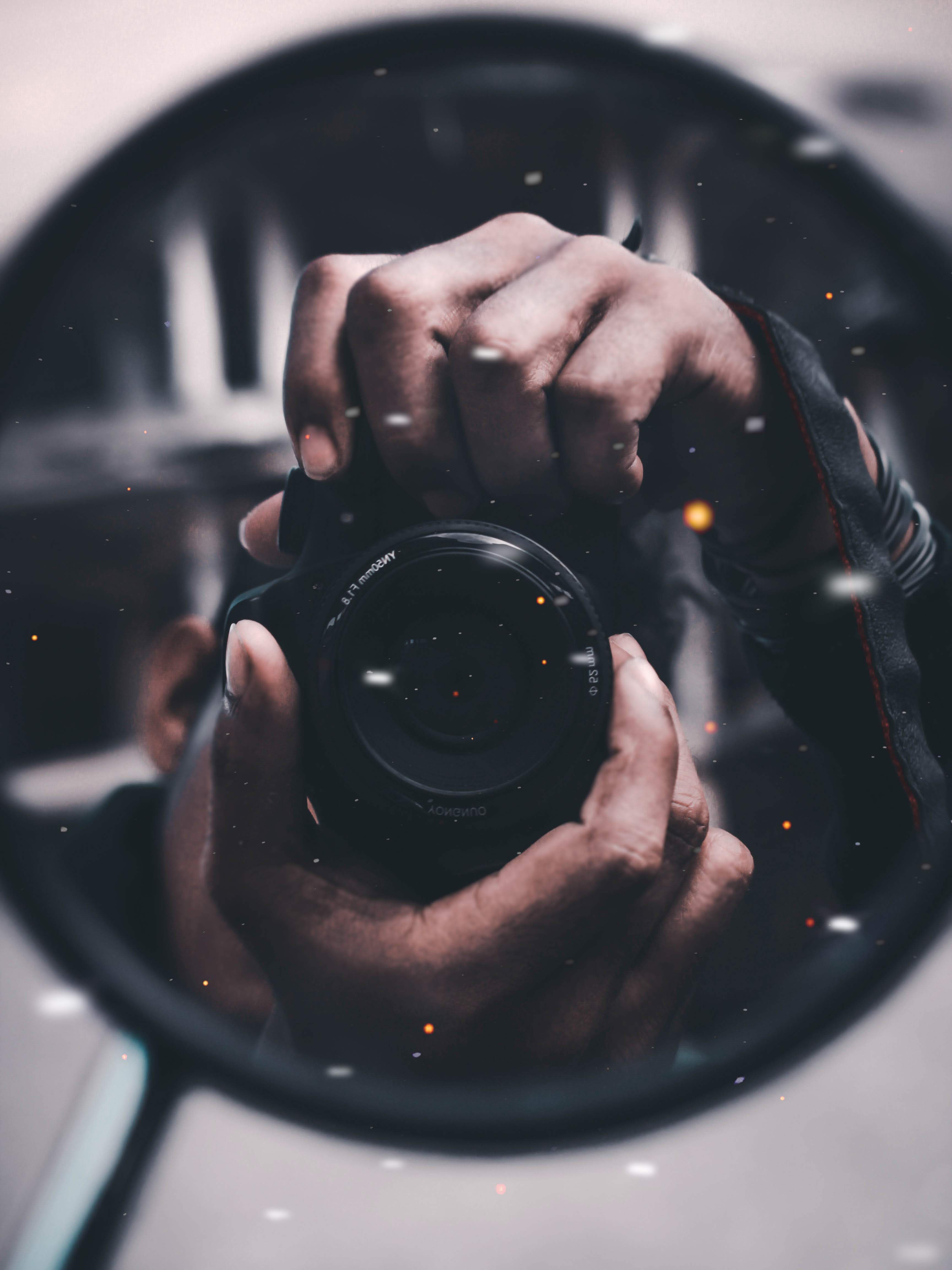 Photographers's self portrait, obscured by camera's reflected image.